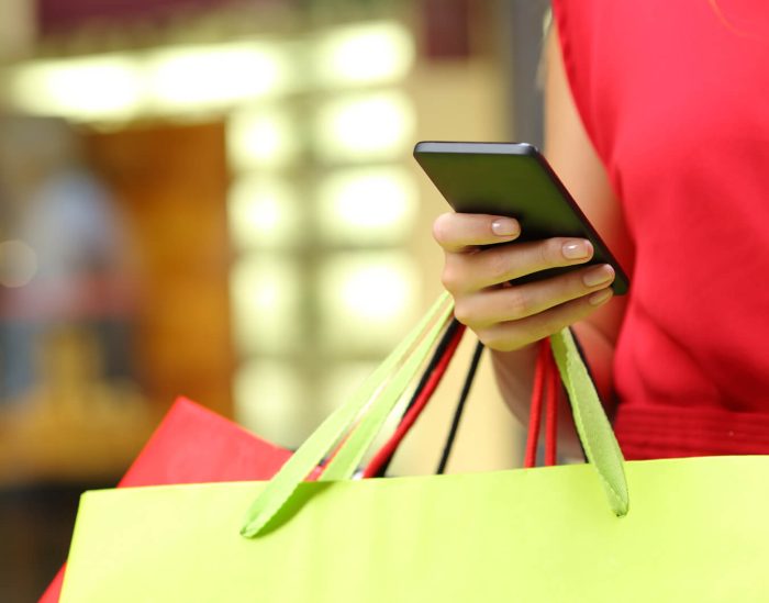 Woman out shopping on mobile device