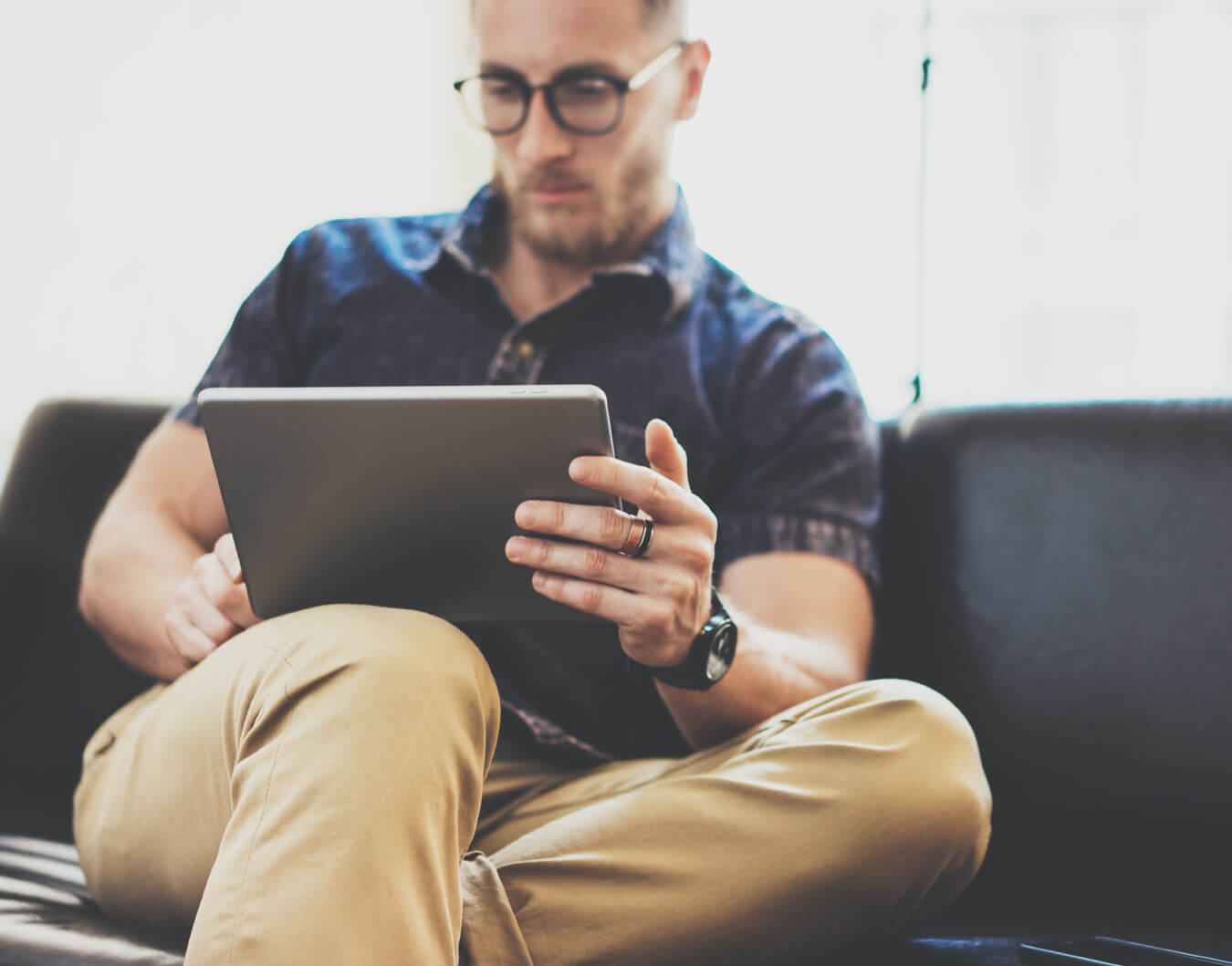 Man browsing on tablet device